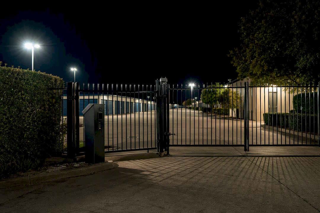 Storage facility gate and fencing at night